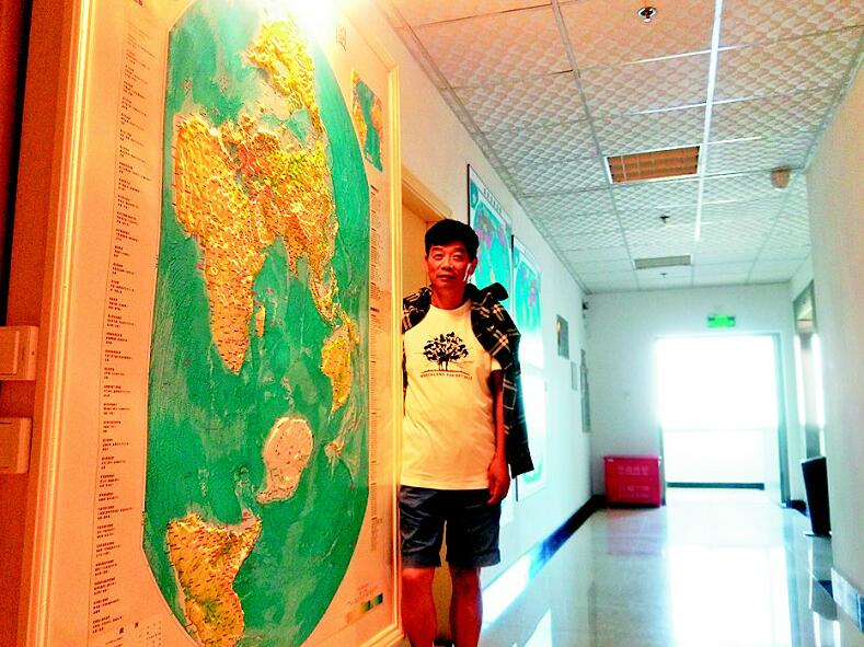 图为:郝晓光和他的竖版世界地图.