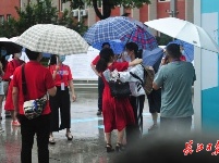 孩子高考，家长在雨中等候